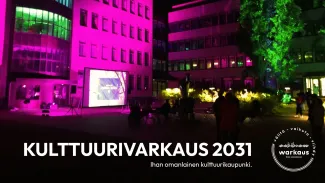Kuvituskuvassa värivaloin valaistu kaupungintalo ja alhaalla teksti: KulttuuriVarkaus 2031 - ihan omanlainen kulttuurikaupunki. Logo Välitä-Vaikuta-Viihdy, Warkaus.