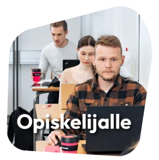 Kolme opiskelijaa tietokoneiden ääressä.